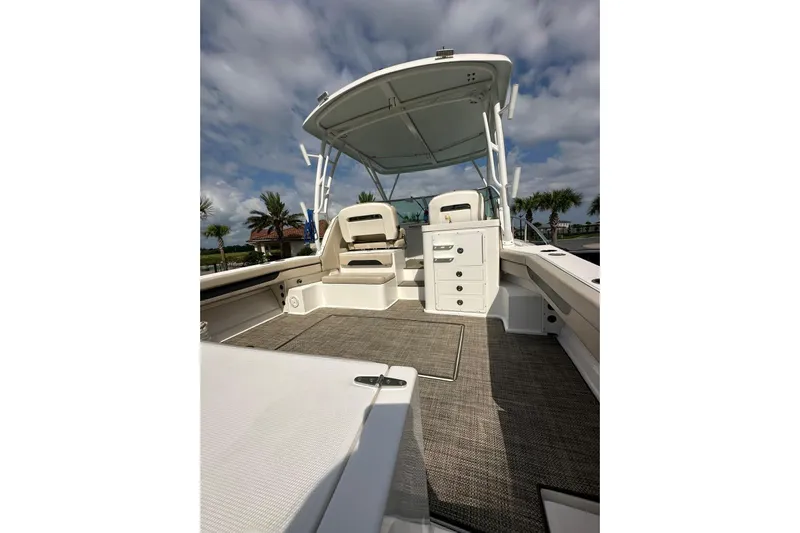  Yacht Photos Pics 2020 Stamas 326 Aegean boat interior with seating and storage, under a cloudy sky.
