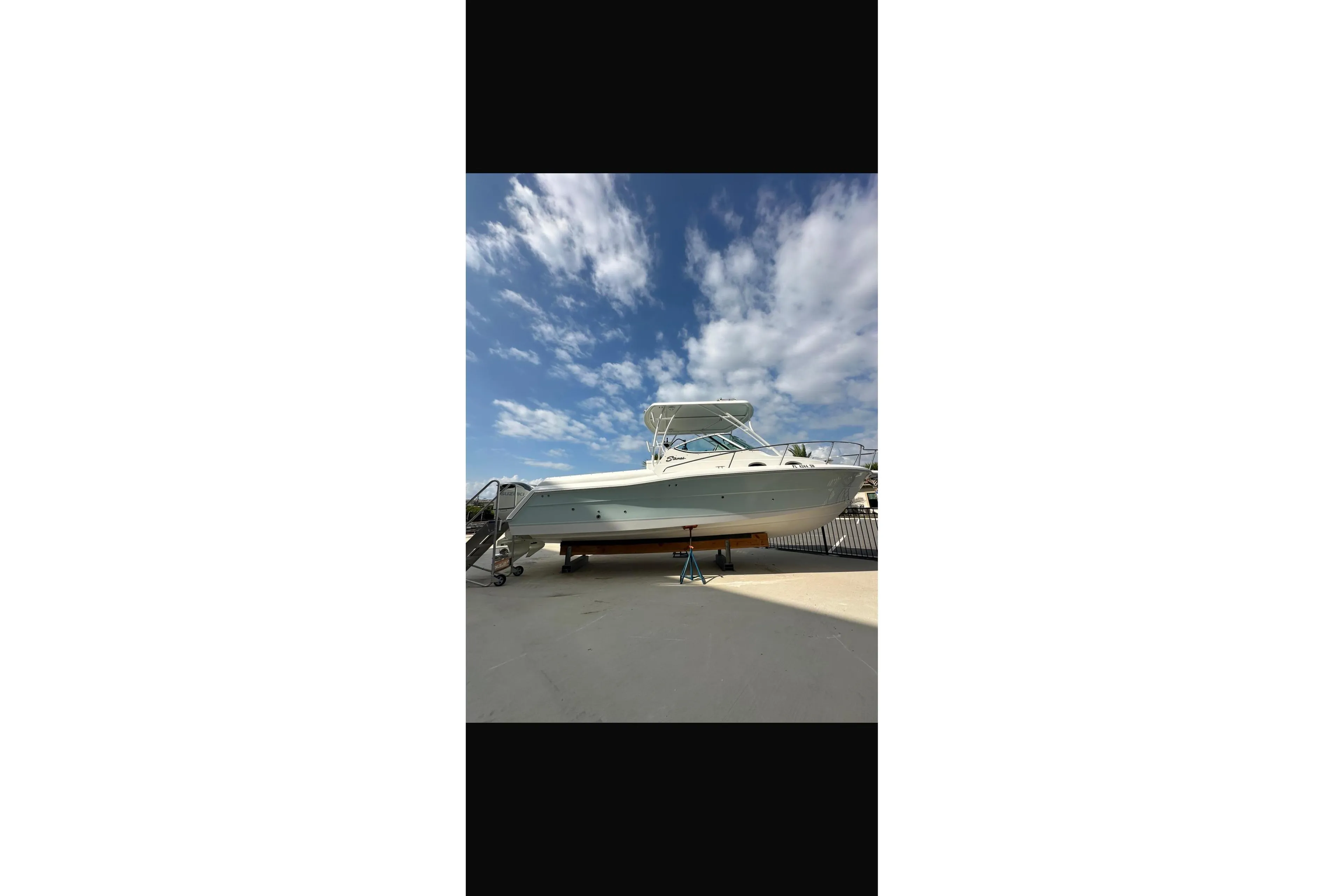 2020 Stamas 326 Aegean boat on dry dock under a blue sky.
