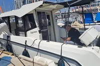2022 Quicksilver 705 Pilothouse boat docked at marina with people onboard.