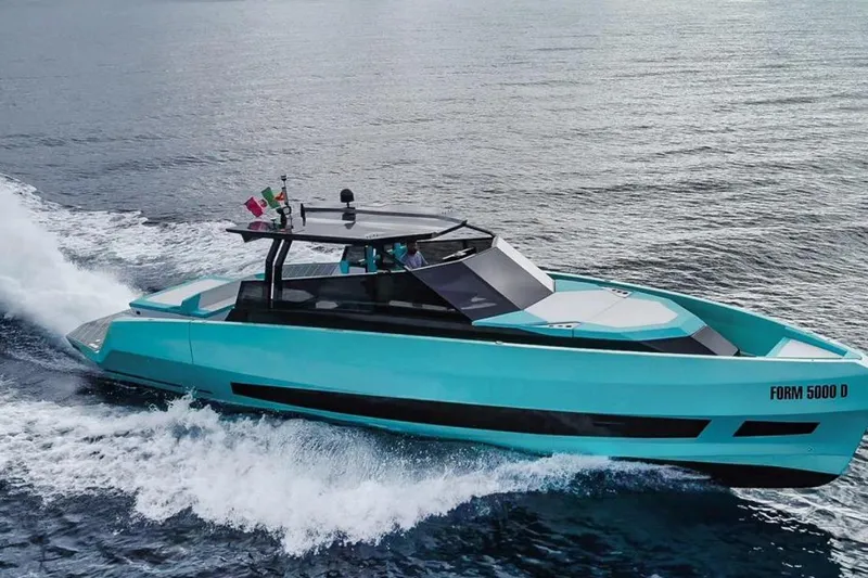  Yacht Photos Pics 2024 Suerte 50 yacht cruising on open water, sleek turquoise design.