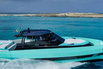  Yacht Photos Pics 2024 Suerte 50 boat cruising in turquoise waters near a sandy island.