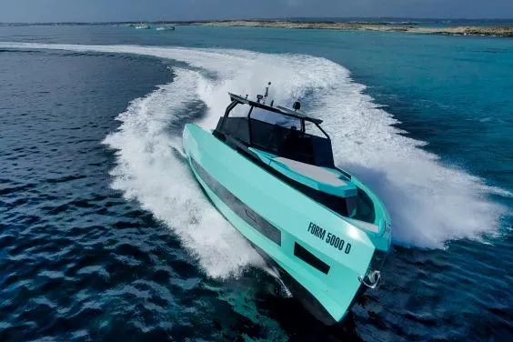  Yacht Photos Pics 2024 Suerte 50 yacht cruising on clear blue waters, showcasing sleek design and speed.