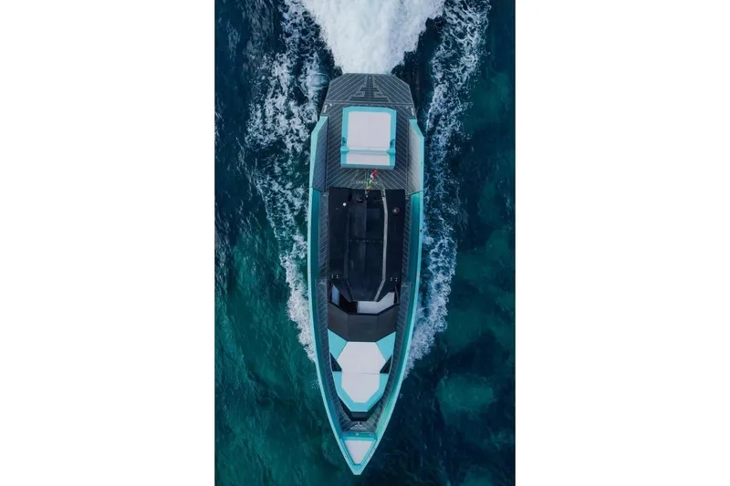  Yacht Photos Pics Aerial view of 2024 Suerte 50 yacht cruising on clear blue water.