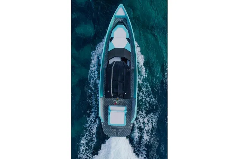  Yacht Photos Pics Aerial view of 2024 Suerte 50 boat cruising on vibrant blue ocean waters.