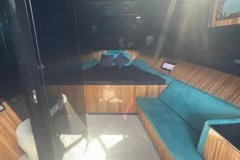  Yacht Photos Pics Luxurious interior of 2024 Suerte 50 yacht with teal seating and wood accents.