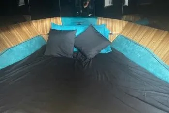  Yacht Photos Pics Luxurious 2024 Suerte 50 yacht interior with elegant bedding and cushions.