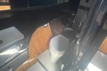  Yacht Photos Pics 2024 Suerte 50 yacht bathroom with modern fixtures and wood accents.