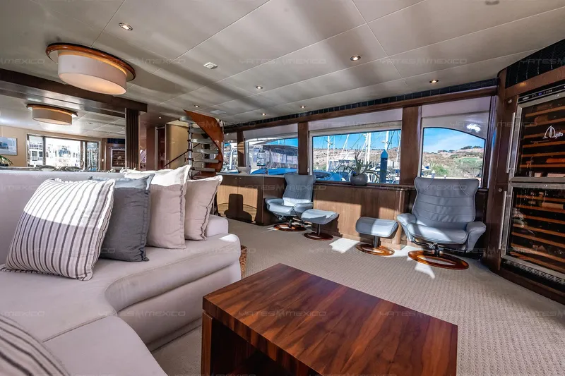 Mijito Yacht Photos Pics Luxurious yacht interior with modern seating, wooden accents, and large windows, Bravo 82, 2002 model.