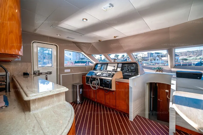 Mijito Yacht Photos Pics Luxurious yacht interior with modern helm, wood accents, and panoramic windows, Bravo 82, 2002 model.