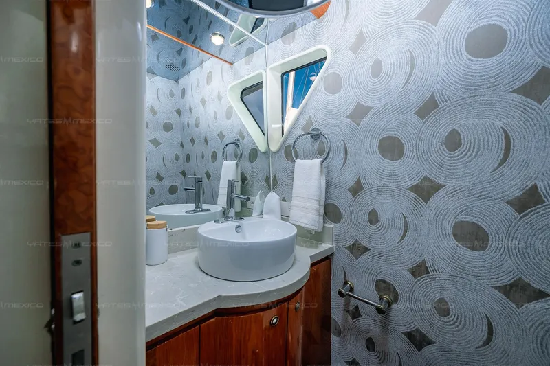 Mijito Yacht Photos Pics Luxurious yacht bathroom with modern sink, circular patterned wallpaper, and elegant fixtures, Bravo 82, 2002.