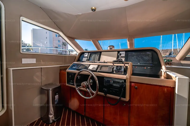 Mijito Yacht Photos Pics Luxurious 2002 Bravo 82 yacht cockpit with modern navigation equipment and wooden accents.