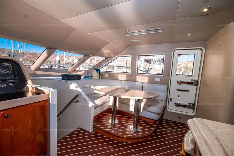 Mijito Yacht Photos Pics Luxurious 2002 Bravo 82 yacht interior with elegant seating and panoramic windows.