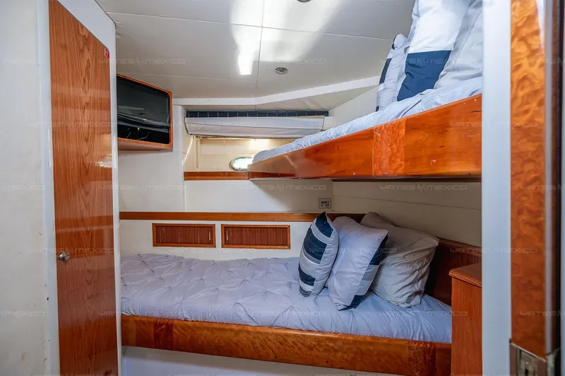 Mijito Yacht Photos Pics Cozy cabin interior with bunk beds on a 2002 Bravo 82 yacht.