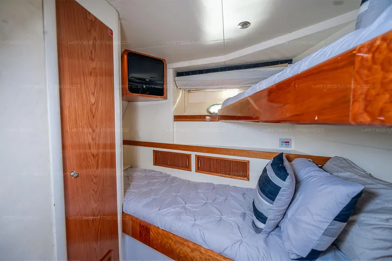 Mijito Yacht Photos Pics Cozy cabin interior of 2002 Bravo 82 yacht with bunk beds and wooden accents.