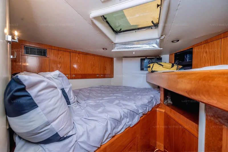 Mijito Yacht Photos Pics Cozy cabin interior of 2002 Bravo 82 yacht with wooden accents and bedding.