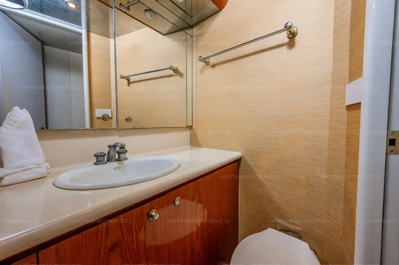 Mijito Yacht Photos Pics Luxurious bathroom interior on Bravo 82 yacht, 2002 model, featuring elegant sink and mirror.