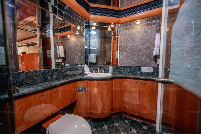 Mijito Yacht Photos Pics Luxurious yacht bathroom with wood cabinetry, marble countertops, and elegant lighting, Bravo 82, 2002 model.