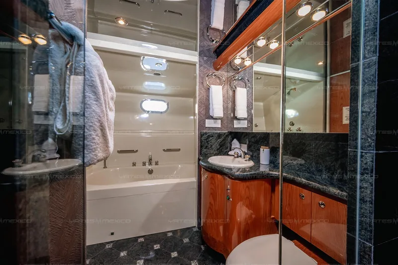 Mijito Yacht Photos Pics Luxurious yacht bathroom with wood accents, mirrors, and modern fixtures, Bravo 82, 2002 model.