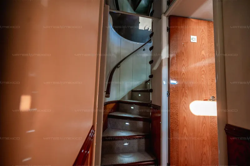 Mijito Yacht Photos Pics Interior of 2002 Bravo 82 yacht with spiral staircase and wooden door.