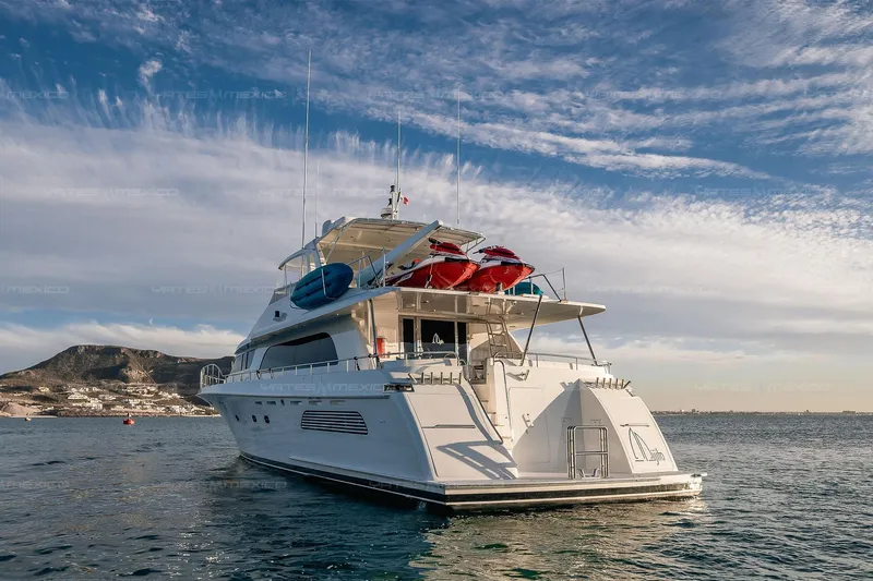 Mijito Yacht Photos Pics Luxurious 2002 Bravo 82 yacht cruising on serene waters under a clear sky.