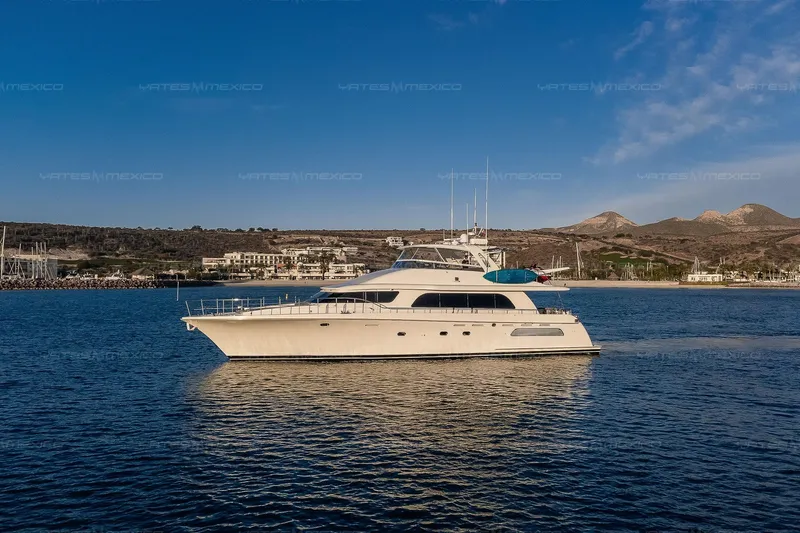 Mijito Yacht Photos Pics Luxurious 2002 Bravo 82 yacht cruising on serene waters with scenic coastal backdrop.