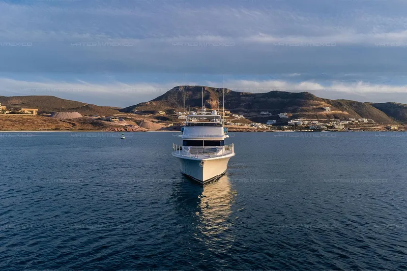 Mijito Yacht Photos Pics Luxury yacht Bravo 82 (2002) on serene waters with scenic coastal backdrop.