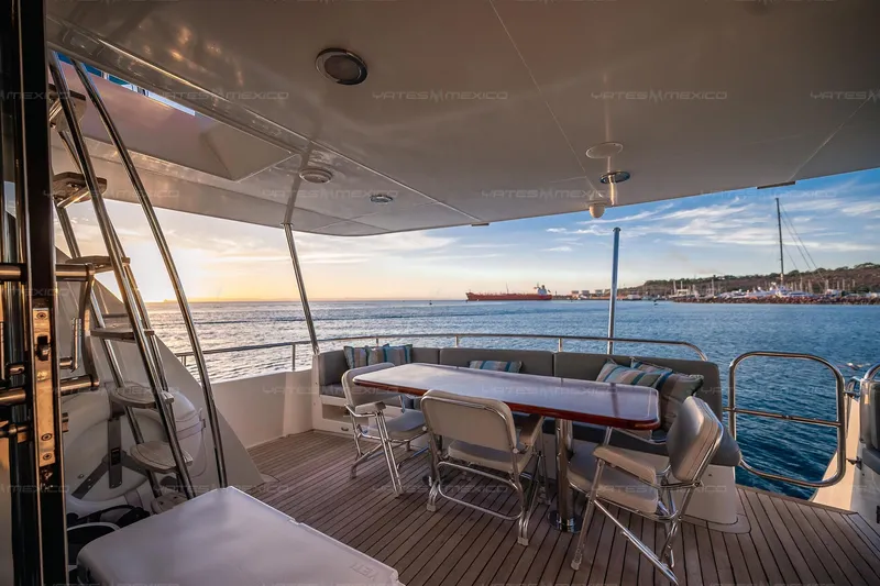 Mijito Yacht Photos Pics Luxurious yacht deck with seating, ocean view, and sunset, Bravo 82 model, 2002.