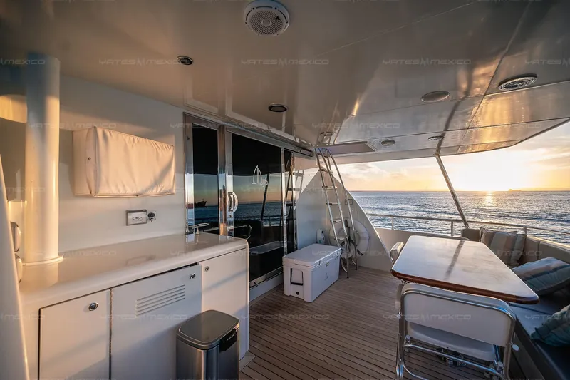 Mijito Yacht Photos Pics Luxurious yacht deck with seating area, ocean view, and sunset, Bravo 82 model, 2002.