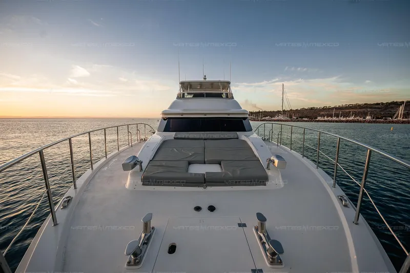 Mijito Yacht Photos Pics Luxurious 2002 Bravo 82 yacht on serene water at sunset.