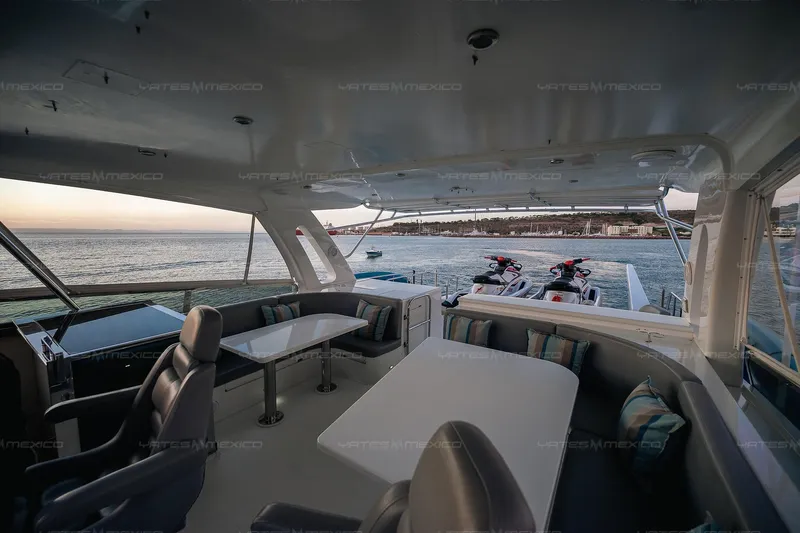 Mijito Yacht Photos Pics Luxurious 2002 Bravo 82 yacht interior with ocean view and jet skis on deck.