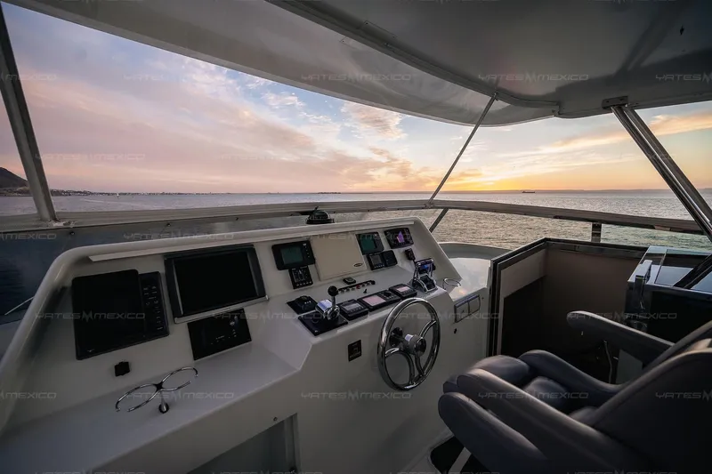 Mijito Yacht Photos Pics Pilot area of 2002 Bravo 82 yacht at sunset, featuring navigation equipment and ocean view.