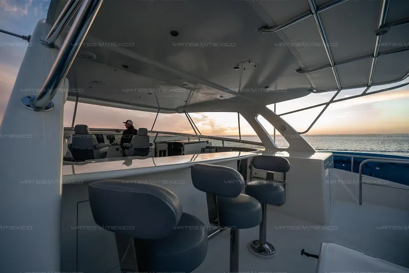 Mijito Yacht Photos Pics Luxurious 2002 Bravo 82 yacht interior with ocean view at sunset.