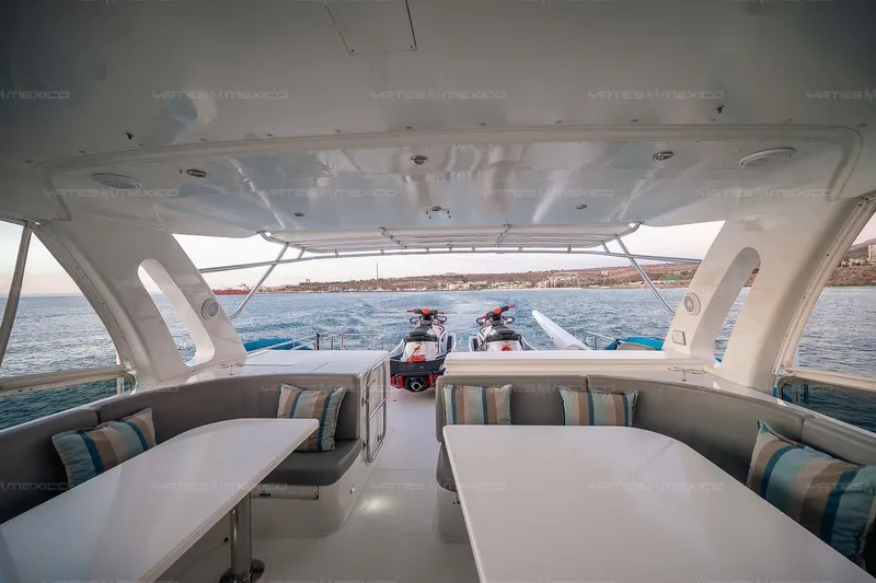 Mijito Yacht Photos Pics Luxurious Bravo 82 yacht interior with seating, tables, and ocean view, 2002 model.