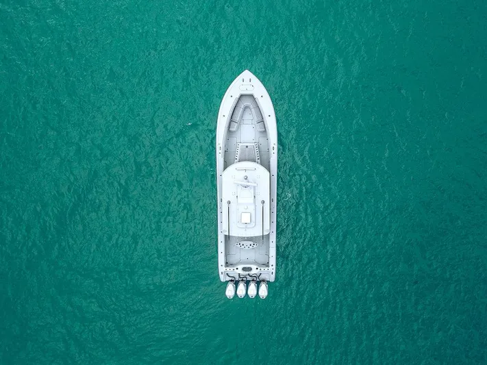  Yacht Photos Pics Aerial view of 2019 Yellowfin 42 boat on turquoise water.