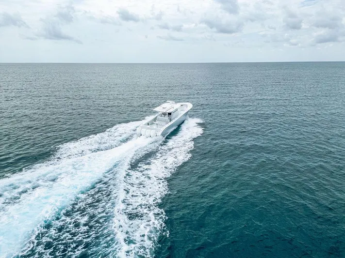  Yacht Photos Pics 2019 Yellowfin 42 boat cruising on open ocean under cloudy sky.