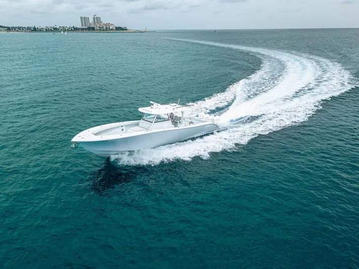  Yacht Photos Pics 2019 Yellowfin 42 boat cruising on open blue water, leaving a white wake trail.
