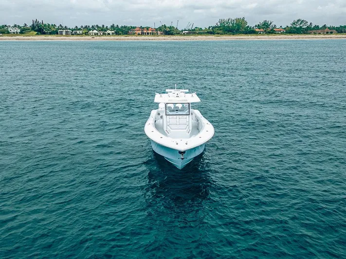  Yacht Photos Pics Aerial view of 2019 Yellowfin 42 boat on calm ocean near shoreline.