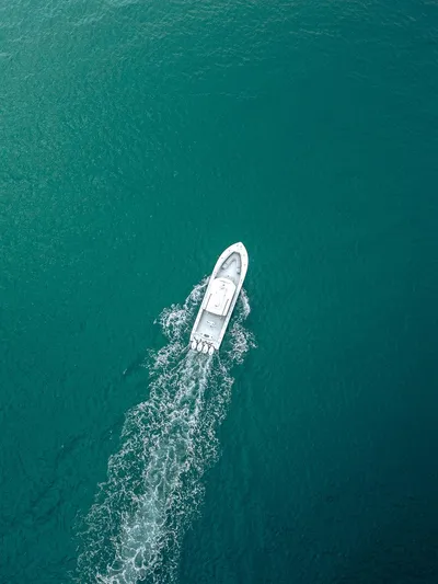  Yacht Photos Pics Aerial view of 2019 Yellowfin 42 boat cruising on turquoise water.