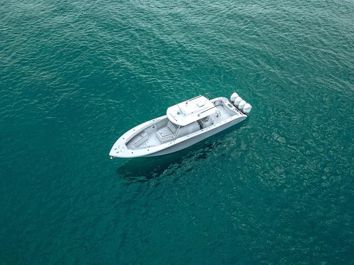 Yacht Photos Pics 2019 Yellowfin 42 boat on clear blue water, aerial view.