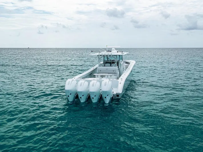  Yacht Photos Pics 2019 Yellowfin 42 boat with four engines on open water under cloudy sky.