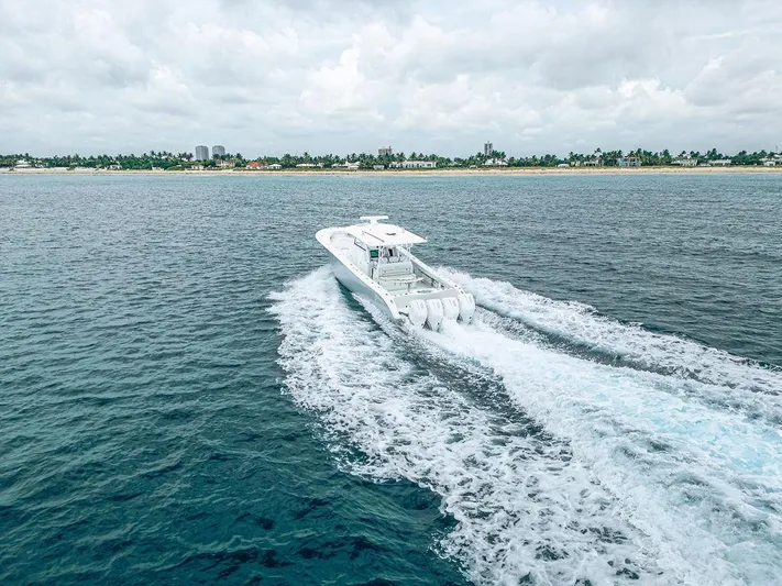  Yacht Photos Pics 2019 Yellowfin 42 boat cruising on open water near a distant shoreline.
