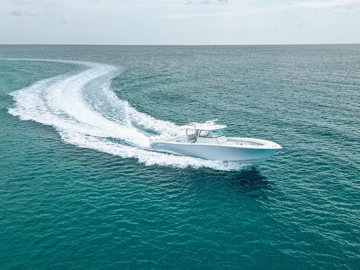  Yacht Photos Pics 2019 Yellowfin 42 boat cruising on open ocean, leaving a wake trail.