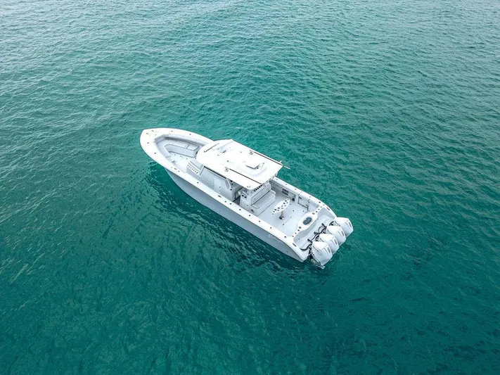  Yacht Photos Pics Aerial view of 2019 Yellowfin 42 boat on clear blue water.