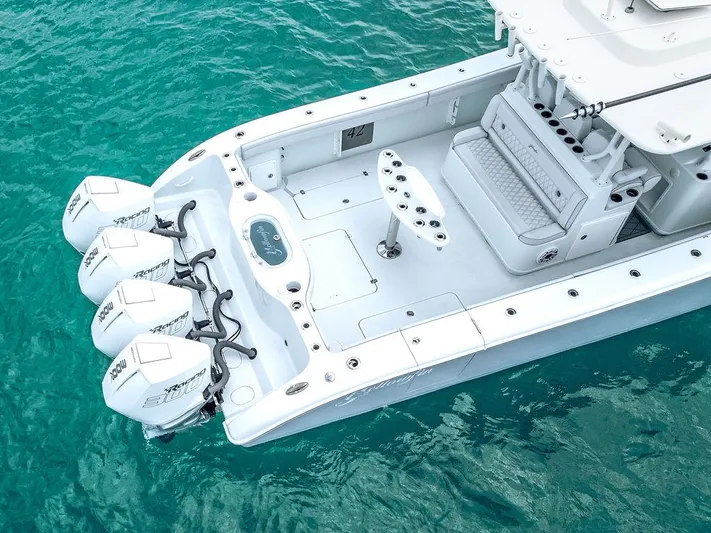  Yacht Photos Pics 2019 Yellowfin 42 boat with triple outboard engines on turquoise water.