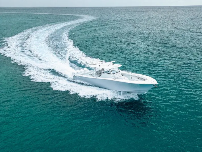  Yacht Photos Pics 2019 Yellowfin 42 boat cruising on clear blue ocean waters.