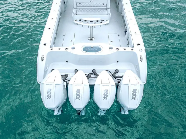  Yacht Photos Pics 2019 Yellowfin 42 boat with four powerful outboard engines on turquoise water.