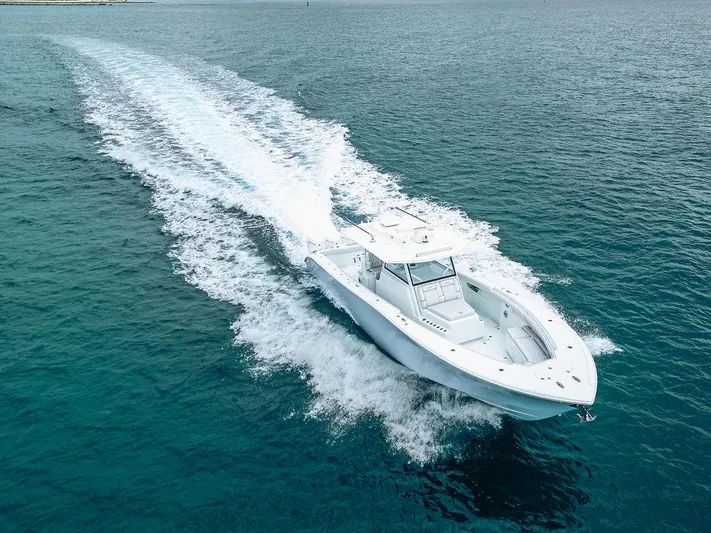  Yacht Photos Pics 2019 Yellowfin 42 boat cruising on open water, leaving a trail of white wake.