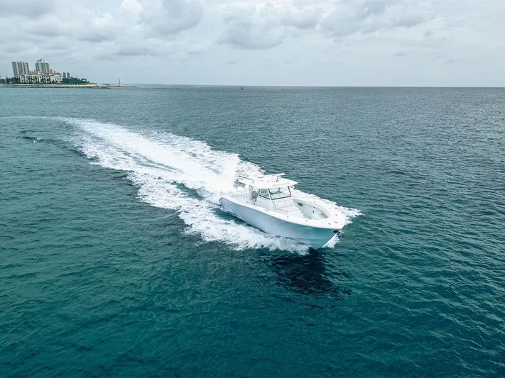  Yacht Photos Pics 2019 Yellowfin 42 boat cruising on open ocean under cloudy sky.