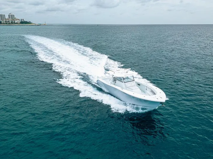  Yacht Photos Pics 2019 Yellowfin 42 boat cruising on open ocean under cloudy sky.