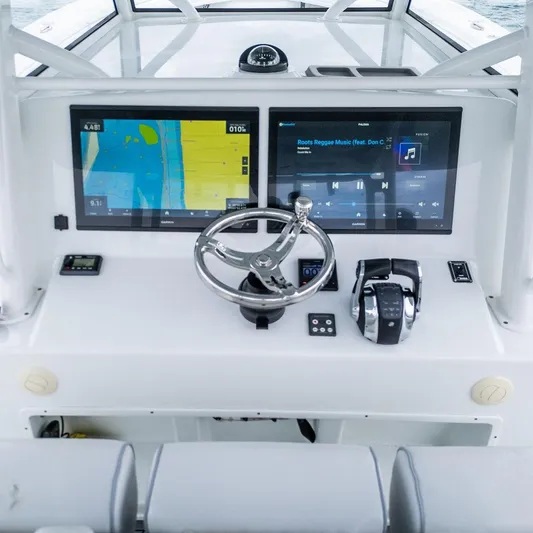  Yacht Photos Pics 2019 Yellowfin 42 boat dashboard with dual screens and steering wheel.